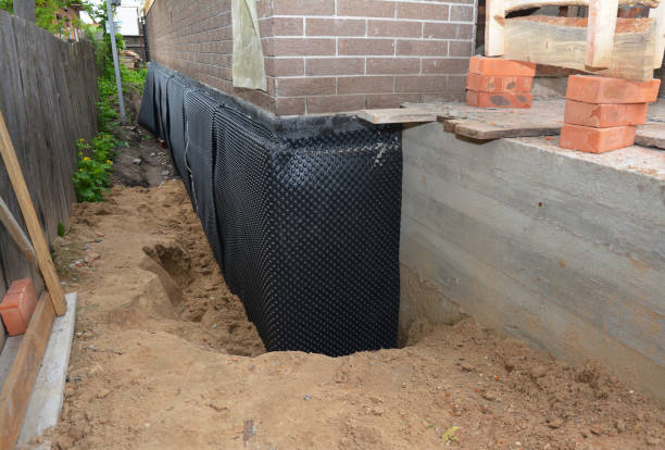 SJ Waterproofing Pros technician performing targeted Interior Drainage System assessment in Columbus, IN